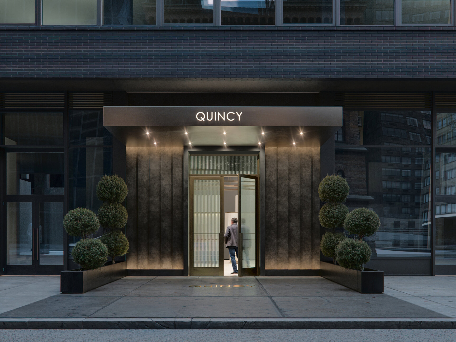 Quincy New York apartment building entrance in Midtown Manhattan at 980 6th Ave.